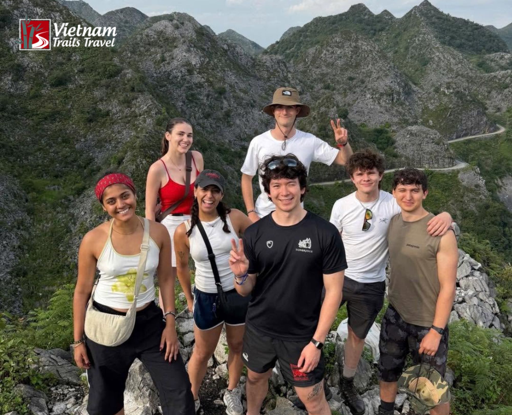 Young international travelers enjoying scenic mountain views during a Ha Giang Loop Tour 4 Days